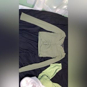 This is a green forever 21 one shirt. It is a crop top and cut low in the front.